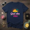 Navy blue t-shirt with "Good Vibes Vibes" text in pink and white, over a sunset and palm tree graphic