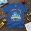 Goodbye Pool Hello SCHOOL t-shirt with a cute whale jumping out of an open book, wearing a graduation cap. Features