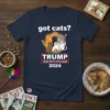 T-shirt with "got cats? TRUMP MAKE PETS LOVE AGAIN 2024" slogan and a graphic of multiple cats wearing hats