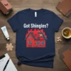 Got Shingles? text above a house on fire with band-aids on the roof, navy blue t-shirt design