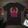 Black t-shirt with "Gracie Glory" repeated in pink, crowned by a gold laurel wreath and pink upward arrow graphic