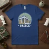 Blue t-shirt with "GREECE" text and a depiction of the Parthenon building, surrounded by a sunburst circle