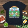 Green Eggs and Bacon text with cute cartoon eggs and bacon illustration under a rainbow on a dark t-shirt