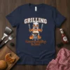 Grilling because adulting is hard text with a bulldog chef on a navy t-shirt, featuring barbecue grill and flames graphic