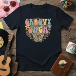 Groovy Gaga text in colorful retro font with flowers, peace signs, and a butterfly graphic on a navy t-shirt