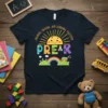 Pre K t-shirt with "Growing, Giggling, and Learning Together" text, sun graphic, rainbow, and school bus
