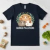 Guinea Pig Lovers t-shirt design featuring three cute guinea pigs in a laurel wreath with a sunset background