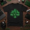 Black t-shirt with "HACK THE PLANET" text in green, featuring a futuristic city skyline and Earth graphic
