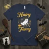 Hairy Furry Halloween T-Shirt with a white dog wearing a witch hat on a broomstick surrounded by paw prints