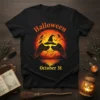 Halloween October 31 t-shirt design featuring a witch hat, black birds, and a full moon with fiery orange and red