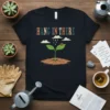 Hang In There inspirational quote t-shirt with a cartoon plant sprout, ladybug, clouds, and rain