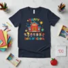 Happy 100 Days of School t-shirt featuring cartoon kids holding hands in front of a schoolhouse and colorful text