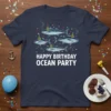 Happy Birthday Ocean Party text with four fish wearing party hats graphic on a navy t-shirt