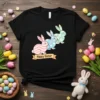 Happy Easter t-shirt design with three pastel-colored bunnies and a festive banner