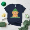 Happy Go Lucky Golden Retriever wearing a green beanie with a St. Patrick's Day theme on a navy t-shirt
