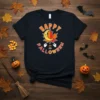 Happy Halloween Trick or Treat t-shirt with a cute moon and leaf graphic, surrounded by ghosts and bats