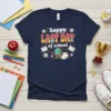 Happy Last Day Of School t-shirt with retro wavy text and school icons like books, globe, and paint palette