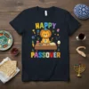Happy Passover t-shirt design featuring a cute cartoon lion wearing a kippah and sitting at a table with Passover food