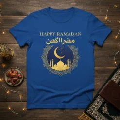 Blue t-shirt with gold text "Happy Ramadan مضر اكن" and a circular graphic of a mosque, crescent moon, and stars