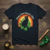 Happy Saint Patrick's Day text with a black cat, shamrocks, and a retro rainbow graphic on a t-shirt