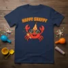 Happy Snappy crab wearing a party hat and sunglasses, holding a party popper, on a navy t-shirt