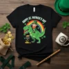 Happy St. Patrick's Day Dinosaur T-Shirt design with a green T-Rex and a leprechaun riding it, under a rainbow and
