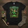 Happy St. Patrick's Day Lucky Charm t-shirt with a green leprechaun holding a horseshoe and staff, surrounded by shamrocks and