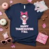 Navy blue t-shirt with "Happy Thanksgiving Y'All" text and a cartoon turkey blowing bubblegum, wearing glasses and a pink bow