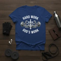 Christian t-shirt with "HARD WORK GOD'S WORK" text, featuring muscular arms lifting a barbell with a cross in the center