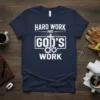 Navy t-shirt with white text "HARD WORK AND GOD'S WORK" featuring a cross and gears graphic
