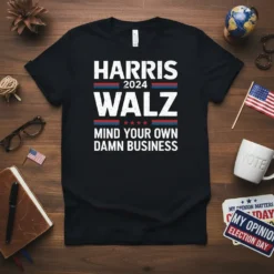 Black t-shirt with white text: HARRIS 2024 WALZ MIND YOUR OWN DAMN BUSINESS, featuring political campaign style design