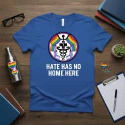 Blue t-shirt with "Hate Has No Home Here" text and a medical caduceus symbol intertwined with rainbow and transgender pride