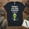 Haters are like crickets quote with a muscular runner and crickets graphic on a dark t-shirt