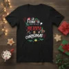 Black t-shirt with "Have a MERRY CHRISTMAS" text in festive red and white lettering, decorated with Santa hat, reindeer, holly