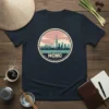 HCMC Vietnam skyline graphic tee featuring the Saigon cityscape in a circular design with pink clouds and teal water