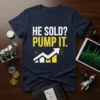 HE SOLD? PUMP IT. text with a rising arrow stock chart graphic on a navy blue t-shirt