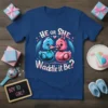 He or She, Waddle It Be? gender reveal t-shirt with cute blue and pink ducks, hearts, and announcement text