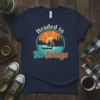 Headed to The Cottage t-shirt design with a rustic cabin, canoe, and sunset over a lake