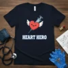 Navy t-shirt with "Heart Hero" text and a cartoon heart with wings and a syringe, representing medical professionals