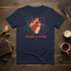 Navy t-shirt with "HEART & HOME" text and a stylized anatomical heart graphic with orbiting lines