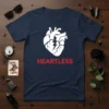 Navy blue t-shirt with a white anatomical heart design and red "HEARTLESS" text, featuring a lightning bolt accent