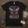 Black t-shirt with "Hecate Goddess World Tour Tickets Sold at the Crossroads" design, featuring winged goddess graphic and occult symbols
