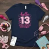 #13th official teenager t-shirt with "hello 13" text and pink heart accents