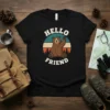 Black t-shirt with "Hello Friend" text and a cute waving bear graphic in a retro sunset circle
