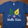 Blue t-shirt with "Hello Keta" text and a stylized cat face featuring green spiral eye and yellow X eye