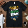 HELLO WE ARE THAT DREAM TEAM THEY TOLD YOU ABOUT text with colorful graphics and gears on a black t-shirt