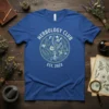 Blue t-shirt with circular design featuring "HERBOLOGY CLUB EST. 2023" text and botanical illustrations