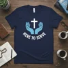 Navy blue t-shirt with white cross and light blue hands, text reads "HERE TO SERVE"