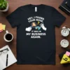 T-shirt with white text reading "Hey I Found Your Nose. It Was In My Business Again." featuring a magnifying glass