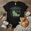 Black t-shirt with "High Body Count Count Hair" text and a green cat graphic in a circle, perfect for cat